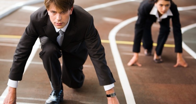Businessman and businesswoman lined up getting ready for race in business